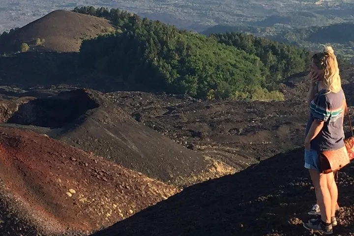 Golden sunset light over the crater rim and lava fields of Mount Etna on a sunset tour from Catania, Sicily