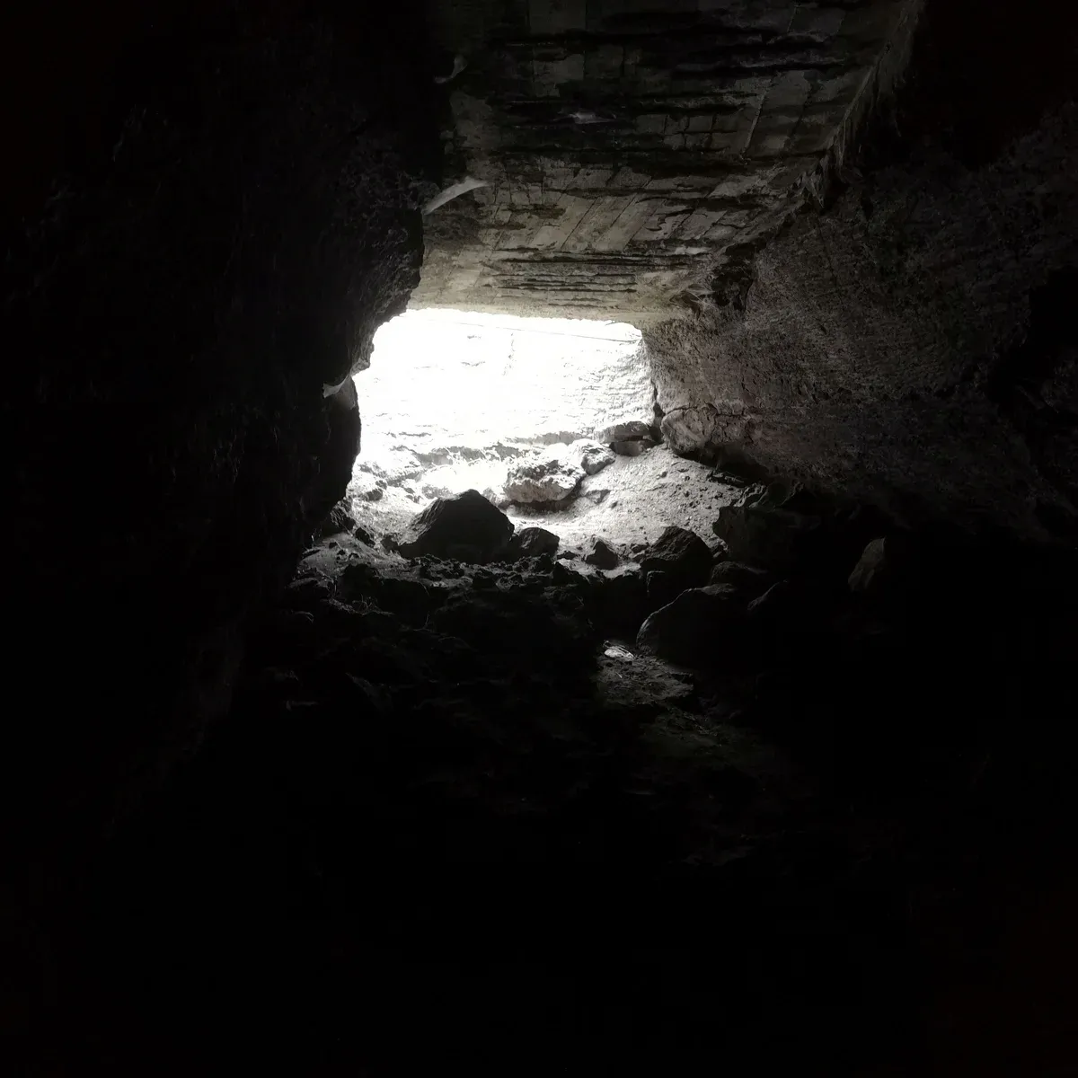 Inside a lava tube cave visited with helmets on a Mount Etna trek and tasting tour, Sicily